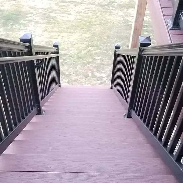 Composite deck stairs with dark railing viewed from above