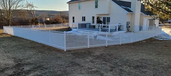 White aluminum fence enclosure surrounding a residential swimming pool